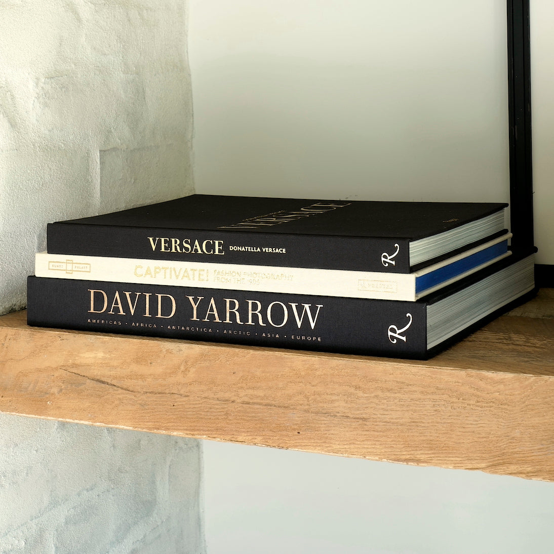 Captivate! Fashion Photography from the '90s - Curated by Supermodel Claudia Schiffer, Published by Prestel - Hardcover, Linen and Gold Front Cover Spine on Book Shelf with Donatella Versace and David Yarrow