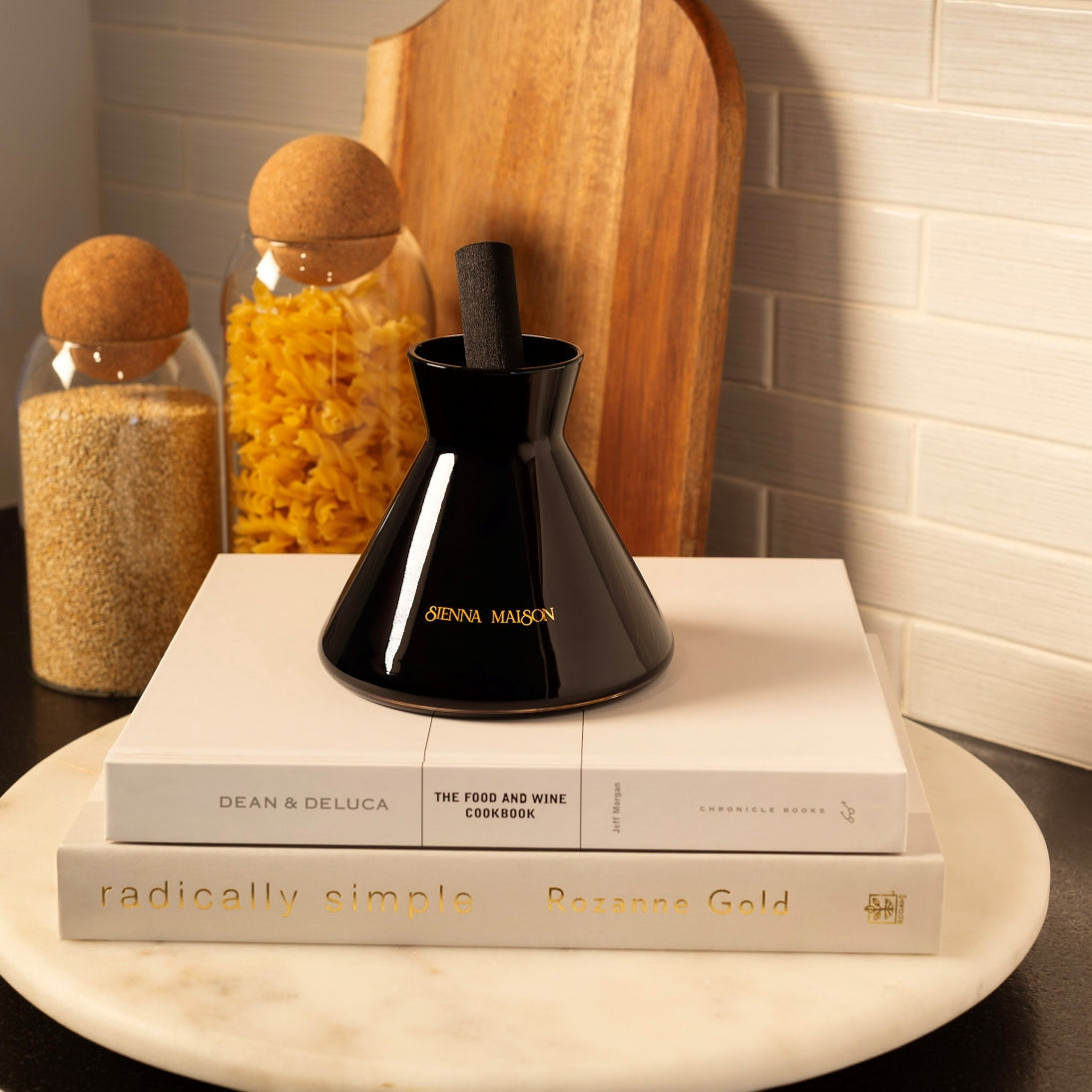 Sienna Maison Gold and Black Dyed Glass Encased in Crystal Glass Lennon Diffuser Set with Thick Reed Styled Display on Kitchen Counter with Madison Borosilicate Glass Cork Canisters