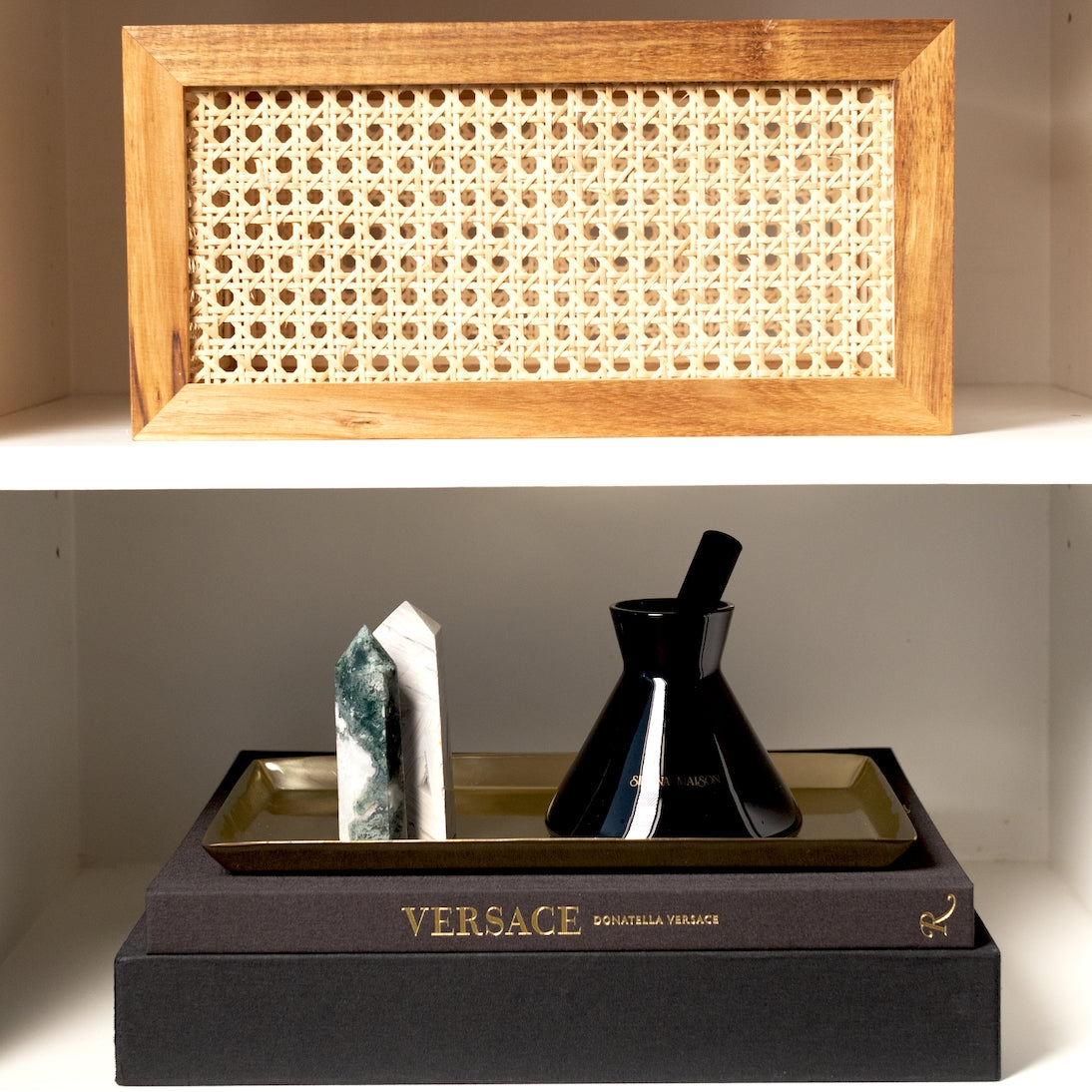 Sienna Maison Limited Edition Moss Agate Crystal Obelisk Tower Point on Shelf with Lennon Diffuser Milo Acacia and Rattan Storage Bin and Donatella Versace Book