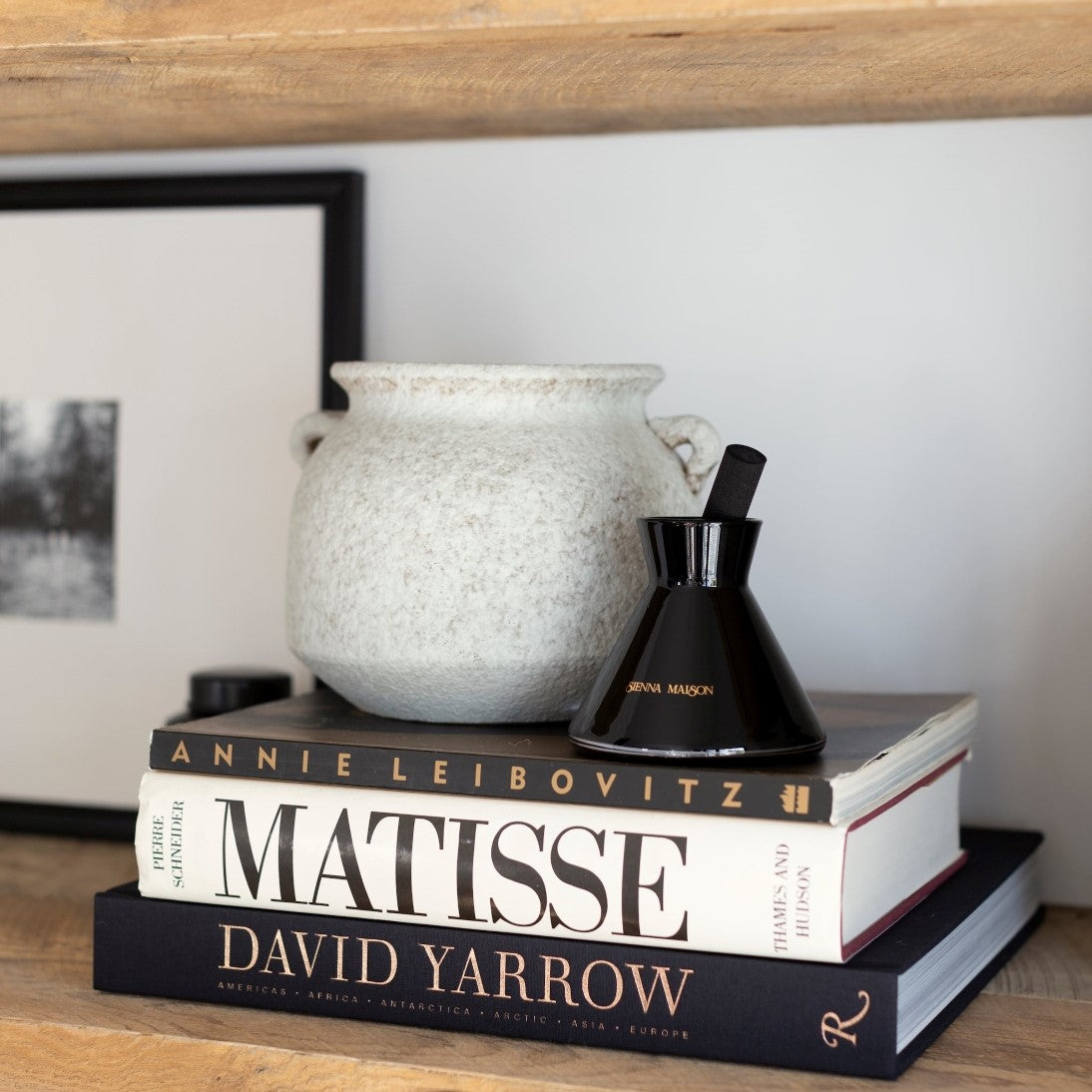 Sienna Maison Hand Made Textured Ceramic White and Natural Savina Rustic Tuscan Vase on Book Shelf with Lennon Diffuser Set and David Yarrow Photography Book